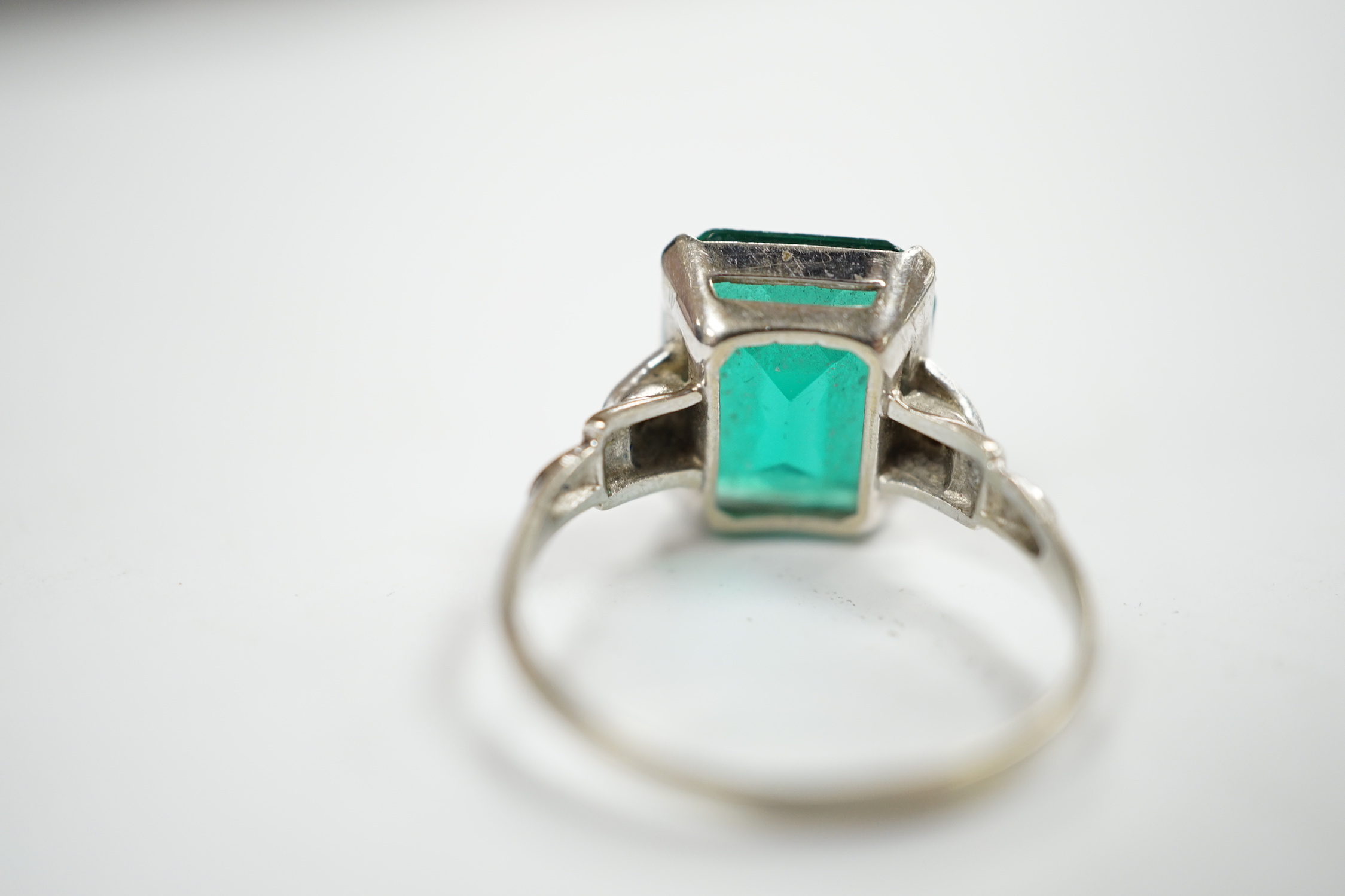 A 14k and single stone green paste set ring, with diamond chip set shoulders, size P, gross weight 3.5 grams.